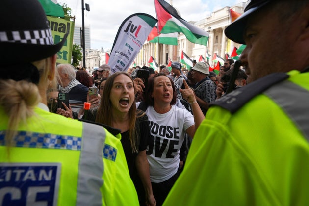 Demonstrators shout and gesture toward a police line during a protest by Palestine Action group in London, Monday, June 23, 2025. (AP Photo/Frank Augstein)