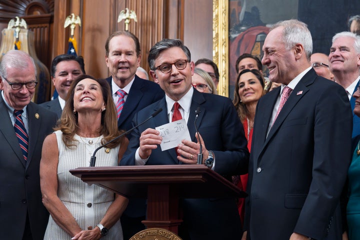 Speaker of the House Mike Johnson, R-La., flanked by Rep. Lisa McClain, R-Mich., left, and Majority Leader Steve Scalise, R-La., right, holds the vote tally sheet as he celebrates with fellow Republicans after final passage of President Donald Trump's signature bill of tax breaks and spending cuts, at the Capitol in Washington, Thursday, July 3, 2025. (AP Photo/J. Scott Applewhite)