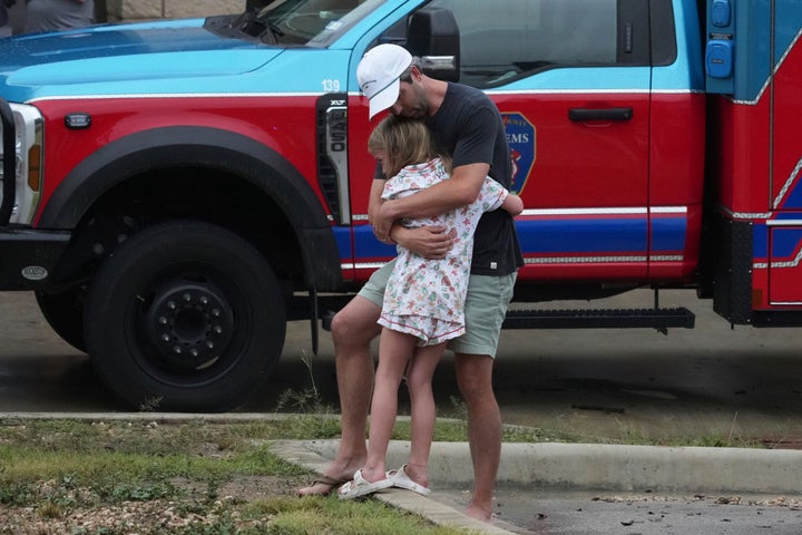 People are reunited at a reunification center after flash flooding hit the area, Friday, July 4, 2025, in Ingram, Texas. (AP Photo/Eric Gay)