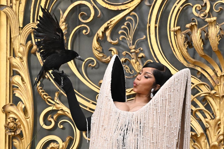 Cardi B Holds Stay, Flapping Crow On Her Arm In Wild Paris Couture Week Look - The Boston Courier 1 Cardi B and the bird share a moment together.