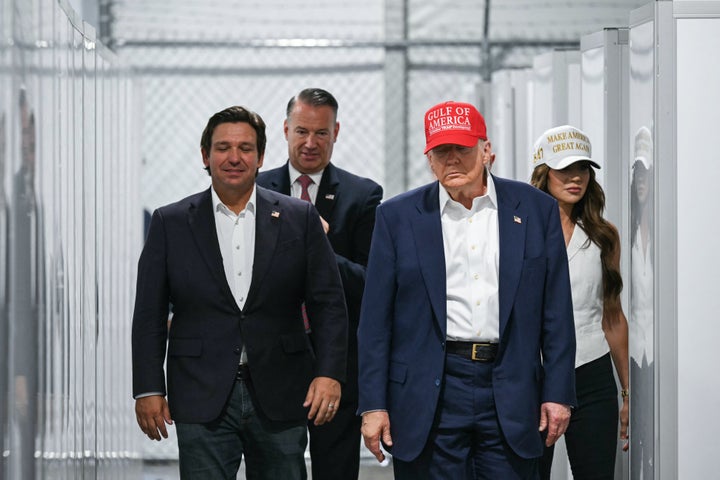 President Donald Trump, Florida Gov. Ron DeSantis and Secretary of Homeland Security Kristi Noem walk through a medical facility section as they tour the migrant detention center dubbed "Alligator Alcatraz" in Ochopee, Florida, on July 1, 2025.