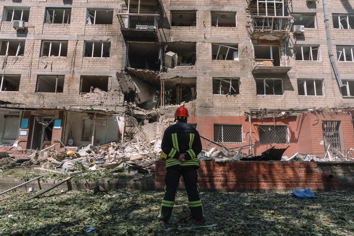 A rescue worker on Friday assesses the site of an airstrike on a residential building in Kyiv, Ukraine. Russia unleashed the airstrikes as U.S. President Donald Trump expressed disappointment over the outcome of his latest phone call with Russian President Vladimir Putin aimed at bringing an end to the war. 