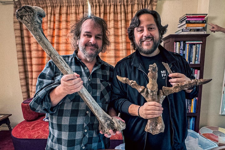 Filmmaker Peter Jackson, left, and Colossal CEO Ben Lamm hold up bones from Jackson's collection of extinct moa bones in Wellington, New Zealand, 2024. (Courtesy of Colossal Biosciences via AP)