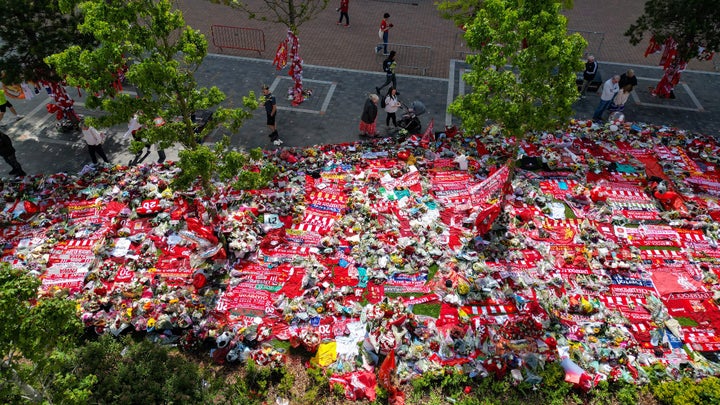 LIVERPOOL, ENGLAND - JULY 07: In this aerial view tributes continue to be laid for Diogo Jota and his brother Andre Silva at Anfield Stadium on July 07, 2025 in Liverpool, England. The current Liverpool player and Portugal international Diogo Jota, 28, was killed in a car crash in Zamora, Spain. He was travelling in a Lamborghini with his younger brother Andre Silva, who also died, returning to the UK for the start of the Premier League season, when the car crashed after a tyre blowout while overtaking a car. Jota leaves behind his wife of two weeks, Rute, and their three young children. (Photo by Christopher Furlong/Getty Images)