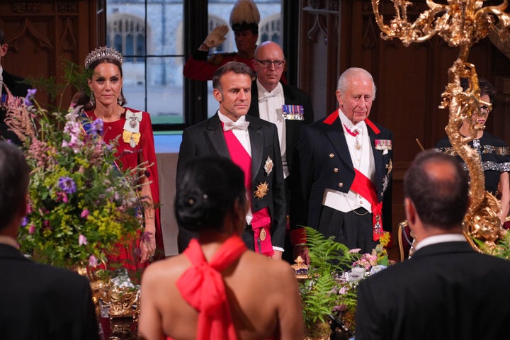 The Princess of Wales, France's President Emmanuel Macron and King Charles III stand during the state banquet. 