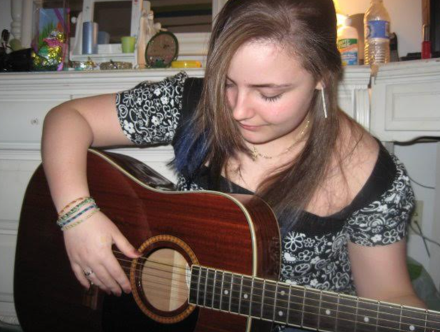 The author playing guitar in her bedroom at the height of her dissociative disorder.