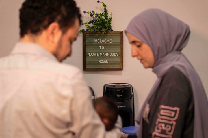 Pro-Palestinian activist Mahmoud Khalil and his wife Dr. Noor Abdalla, hold their baby Deen during an interview, July 3, 2025, in New York. (AP Photo/Yuki Iwamura)