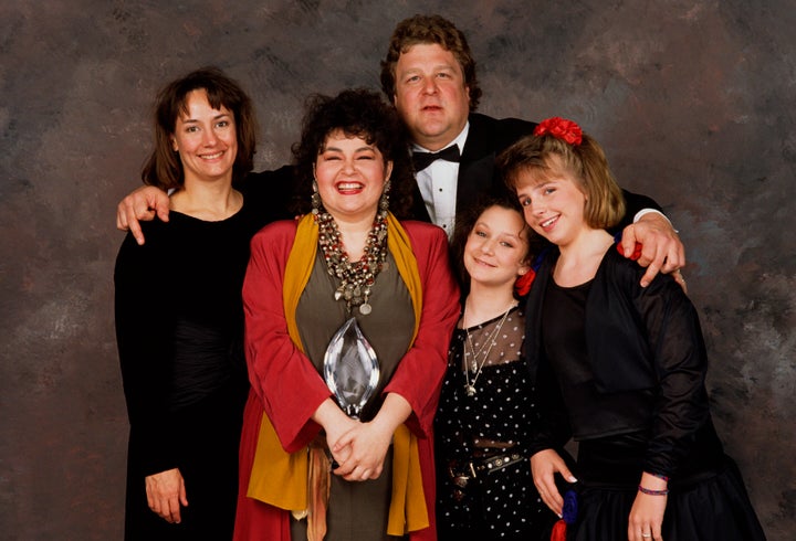 The cast of "Roseanne": (l-r) Laurie Metcalf, Roseanne Barr, John Goodman, Sara Gilbert and Lecy Goranson, pose backstage after winning the 1989 People's Choice Award for best TV Comedy in Beverly Hills, California.