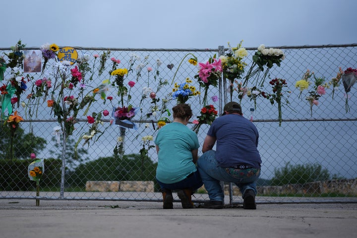 Visitors place items on a memorial wall for flood victims, Sunday, July 13, 2025, in Kerrville, Texas. (AP Photo/Eric Gay)