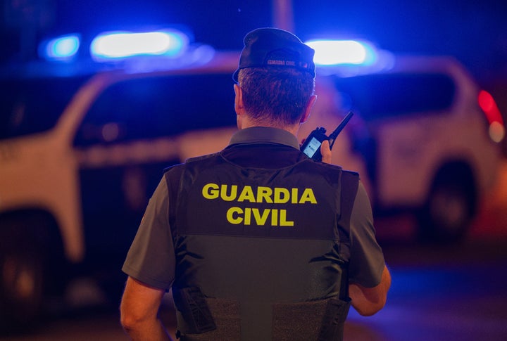 A constabulary serviceman pinch nan Civil Guard listens to instructions connected his walkie-talkie during a 3rd nighttime of riots successful Torre Pacheco, Murcia, Spain.