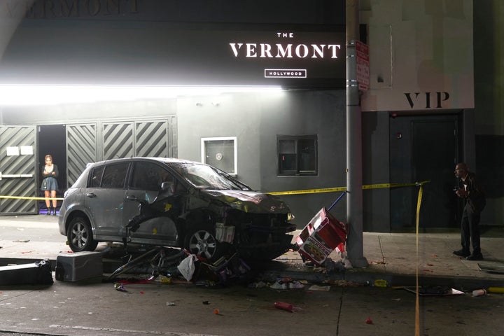 A vehicle sits on the sidewalk after ramming into a crowd of people waiting to enter a nightclub along a busy boulevard in Los Angeles early Saturday, July 19, 2025 injuring several people. (AP Photo/Damian Dovarganes)
