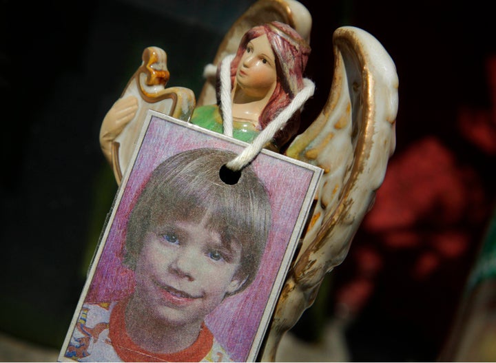An image of Etan Patz hangs on an angel figurine, part of a makeshift memorial in the SoHo neighborhood of New York where the boy lived.