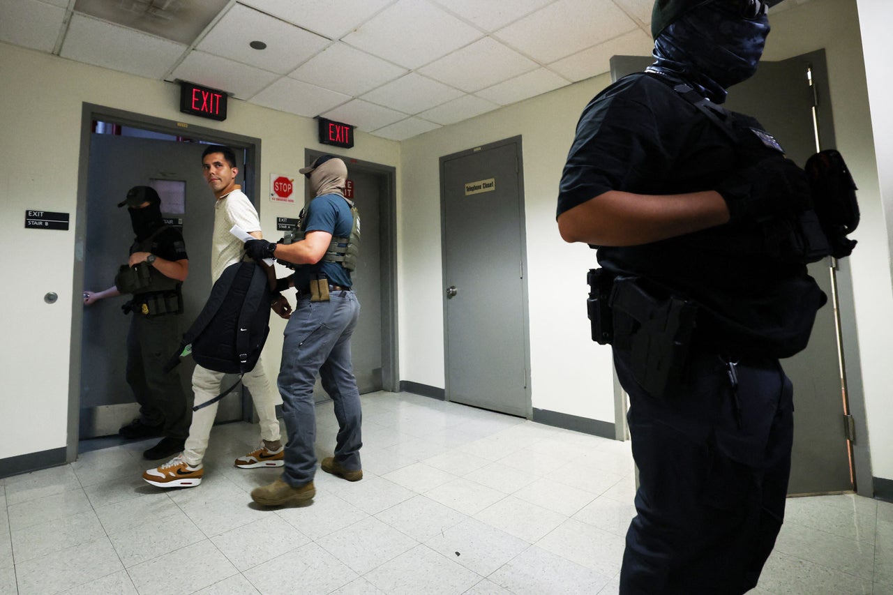 A man is detained by federal officers after his court hearing at New York Federal Plaza Immigration Court inside the Jacob K. Javits Federal Building in New York on July 17, 2025.