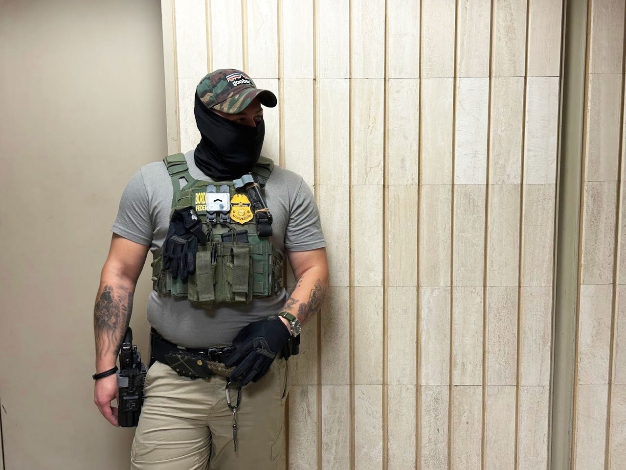A Border Patrol agent wearing a "goober" hat and a knife stands near the elevators at New York Federal Plaza Immigration Court inside the Jacob K. Javits Federal Building in New York on July 14, 2025.