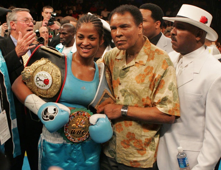 Ali celebrates with her iconic pop after a super middleweight title bout in 2005.