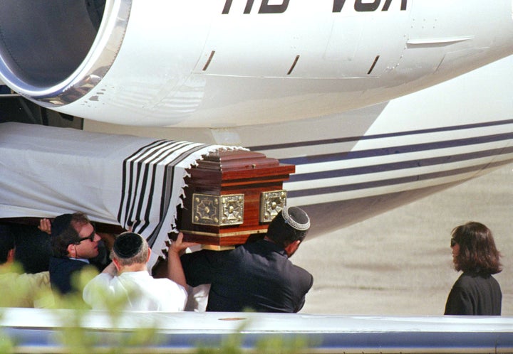 Ghislaine Maxwell, far right, looks on as the casket containing the body of Robert Maxwell is unloaded from a plane in Jerusalem, Nov. 8, 1991. The body of the 68-year-old Jewish publisher arrived via private jet from the Canary Islands, a Spanish island group off the Moroccan coast.