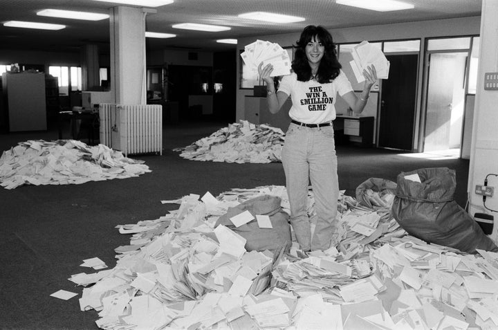 Ghislaine Maxwell, daughter of Mirror Group publisher Robert Maxwell, sifts through mountains of "Draw Coupon" entries at Maxwell House in September 1984.