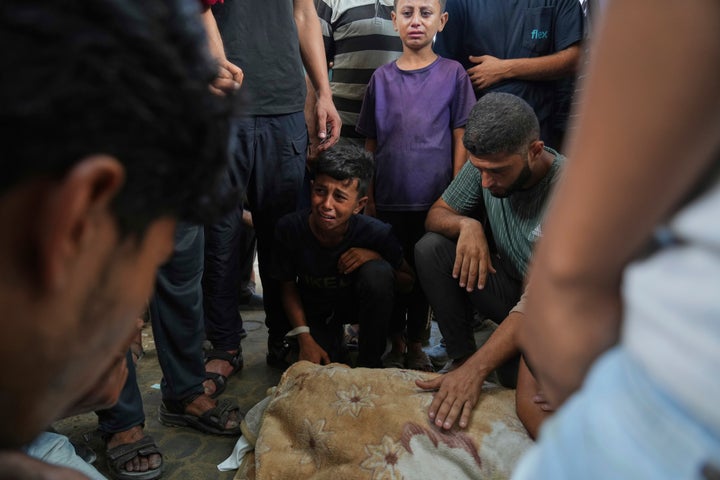 Abdul Karim Foura, center, mourns over the body of his uncle, Mohammed Foura, who was killed in an Israeli airstrike in Gaza Strip, outside the morgue of the Shifa Hospital, in Gaza City, Saturday, July 26, 2025. (AP Photo/Abdel Kareem Hana)