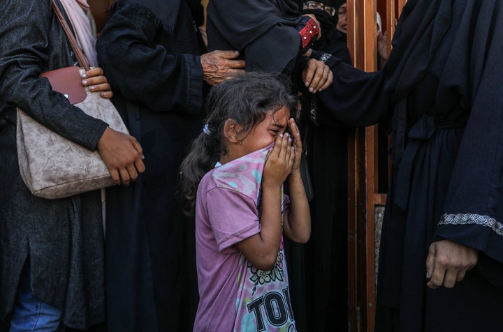 Palestinians who lost their relatives in Israeli attacks mourn as the deceased are brought to Nasser Hospital in Gaza's Khan Younis on July 28, 2025.