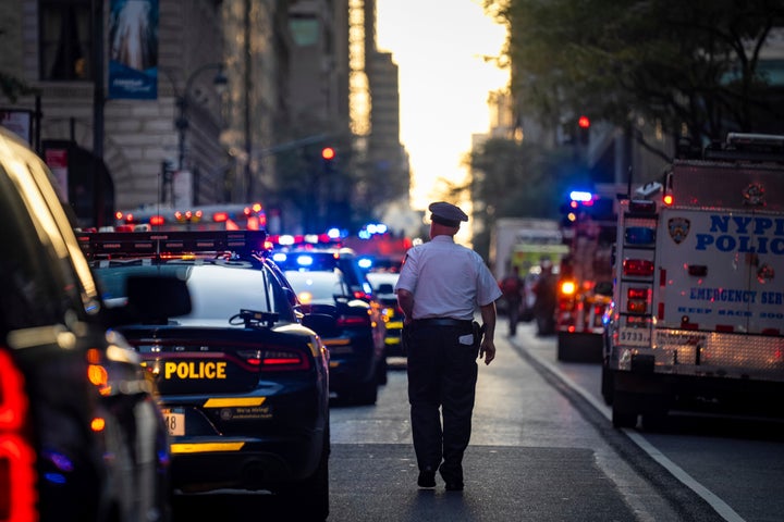 A police officer walks in front of the scene of the shooting.