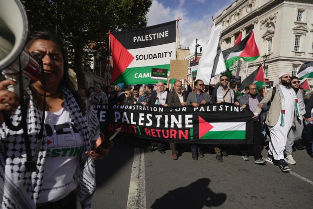 Protesters attend a pro Palestinian demonstration in London, Saturday, Oct. 14, 2023. Palestine Solidarity Campaign hosts march in support of Palestinians caught up in the war between Israel and Hamas. 
