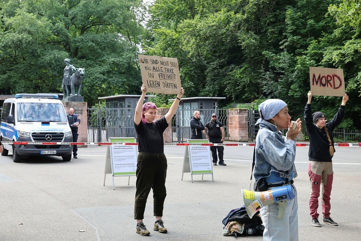 Demonstrators stand with protest signs in front of the Nuremberg Zoo in Nuremberg, Germany, Tuesday, July 29, 2025. Slogan reads 'we won't remain silence until all animals can live in freedom'. (Daniel Loeb/dpa via AP)