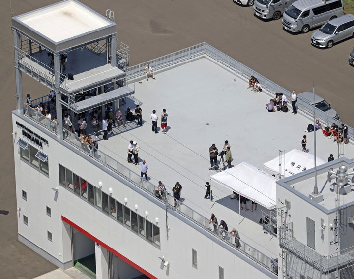 8.8 Magnitude Quake Strikes Off Russia's Far East. Tsunami Waves Attain Japan, Hawaii And California 2 People take shelter on the roof of a fire station in Mukawa town, Hokkaido, northern Japan Wednesday, July 30, 2025, after a powerful earthquake in Russia's Far East prompted tsunami alert in parts of Japan. (Kyodo News via AP)