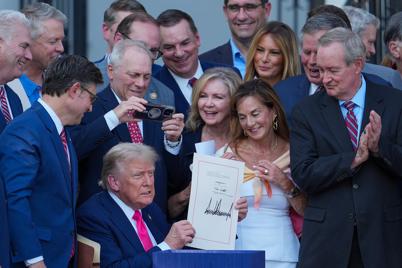 President Donald Trump, joined by Republican lawmakers, signs the reconciliation bill on July 4, 2025, giving $165 billion in additional funding to immigration officials.