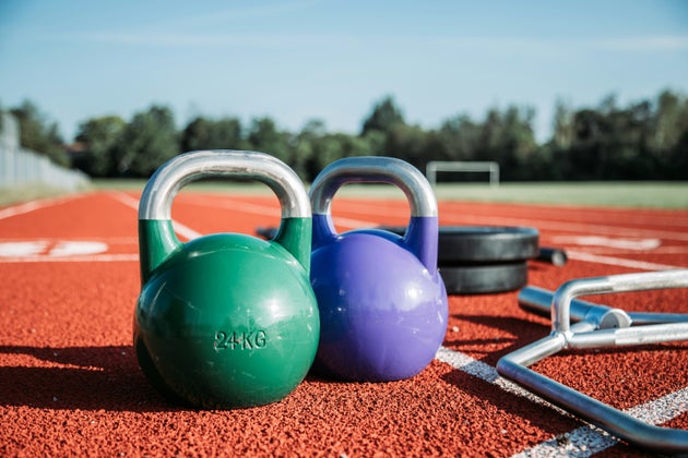 Two kettlebells on running track.