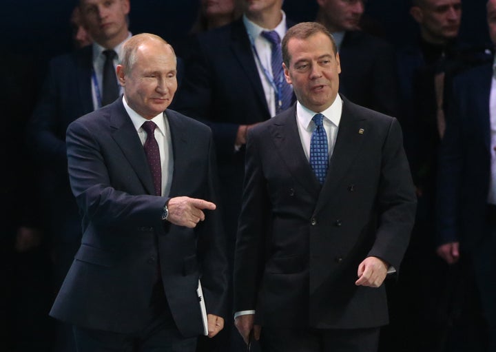 Russian President Vladimir Putin (left) and then-Prime Minister Dmitry Medvedev enter the hall during the XIX Congress of United Russia Party in November 2019 in Moscow.