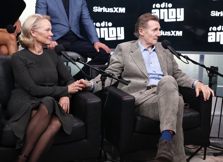 Pamela Anderson and Liam Neeson hold hands during SiriusXM's Town Hall with the cast of "The Naked Gun" on Wednesday.