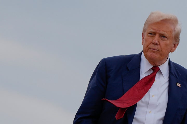 President Donald Trump walks to board Air Force One, Friday, Aug. 1, 2025, at Joint Base Andrews, Md. (AP Photo/Julia Demaree Nikhinson)
