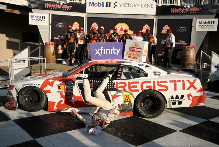 Connor Zilisch slips and falls off his car in victory lane after winning the NASCAR Xfinity Series race in Watkins Glen, New York. 