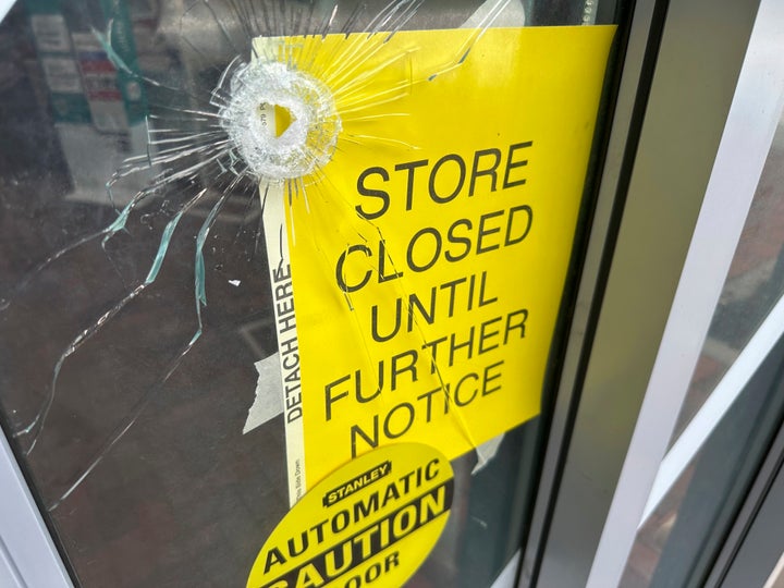 A bullet hole is visible in the door of a CVS pharmacy on Saturday, August 9, 2025, near where police say a man was shooting at the headquarters of the U.S. Centers for Disease Control and Prevention in Atlanta. (AP Photo/Jeff Amy)