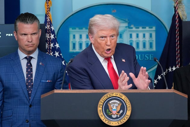 President Donald Trump speaks with reporters in the James Brady Press Briefing Room at the White House, Monday, Aug. 11, 2025, in Washington, as Secretary of Defence Pete Hegseth looks on.
