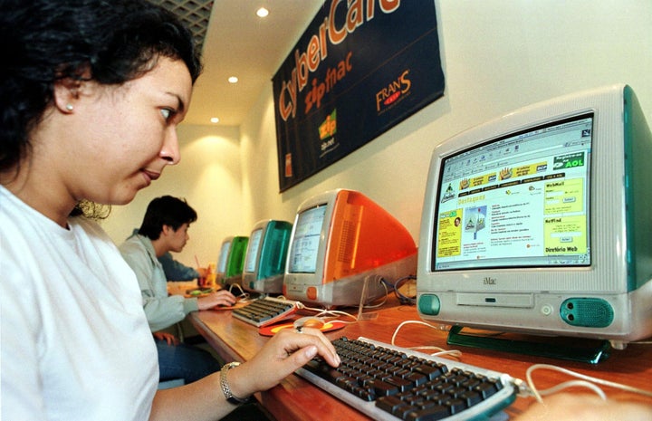 A woman logs onto AOL while surfing the internet at a cybercafe in Sao Paulo, Brazil, in 1999.
