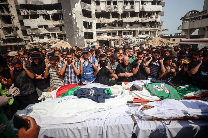 Mourners pray during a group funeral for Palestinians, including journalists and a medic, killed in an overnight Israeli strike, outside the Al-Shifa Hospital in Gaza City, on Aug. 11.