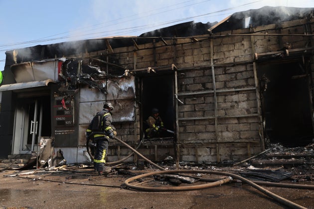 Rescue workers put out a fire at a commercial store, destroyed by a Russian missile attack on Zaporizhzhia, Ukraine, Monday, Aug. 18, 2025. (AP Photo/Kateryna Klochko)