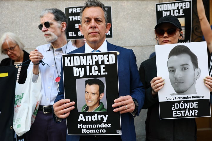 New York State Assembly member Tony Simone holds a photo of Venezuelan makeup artist Andry Hernandez Romero as he protests against the deportation of immigrants to El Salvador.