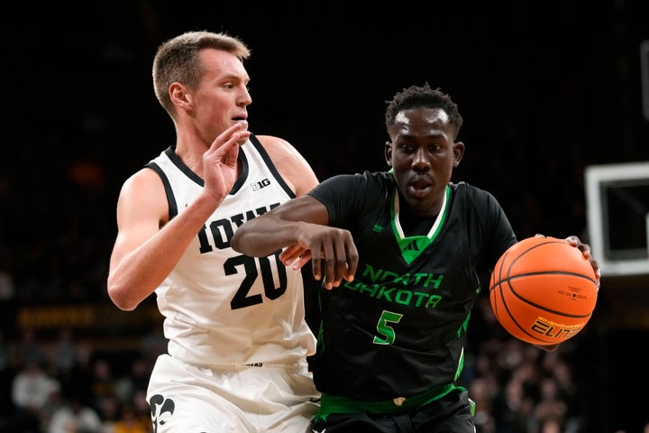 Deng Mayar (5) drives past Iowa forward Payton Sandfort (20) during the first half of an NCAA college basketball game on Nov. 7, 2023, in Iowa City, Iowa.