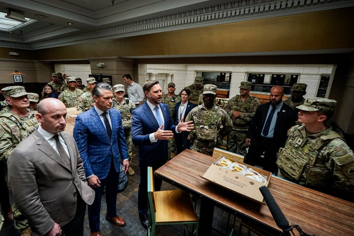 U.S. Vice President JD Vance, joined by Defense Secretary Pete Hegseth (2nd L) and White House Deputy Chief of Staff Stephen Miller (L) speaks with members of the National Guard during a visit to Union Station on August 20, 2025 in Washington, D.C.