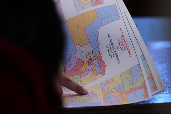 The state representative of Texas, Marc Lahood, looks at a map while legislators prepare to discuss a map of the US Congress in Texas during a special, Wednesday, August 20, 2025, in Austin, Texas. (AP Photo/Eric Gay)