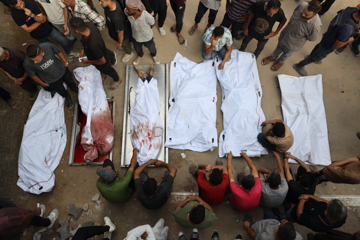 Loved ones at Al-Shifa Hospital mourn over the bodies of Palestinians, including children, who were killed by Israeli airstrikes in Gaza City's residential neighborhoods, on Aug. 21, 2025.