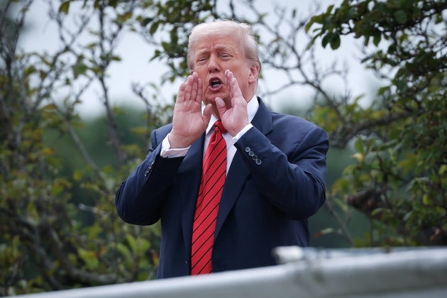 US President Donald Trump shouts answers to questions from reporters as he tours the roof of the West Wing of the White House on August 05, 2025