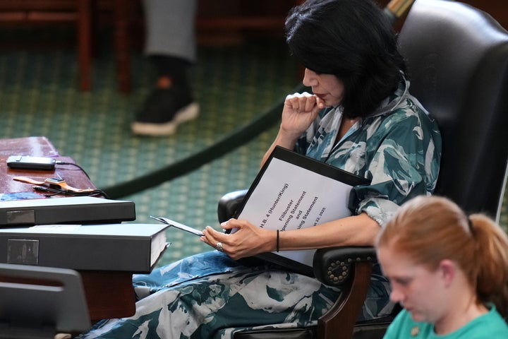 Texas state senator, Carol Alvarado, Houston Democrat, looks at the notes while preparing to archive a bill on a map of the US Congress.