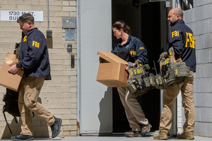 FBI agents carry boxes from former National Security Advisor John Bolton's office in Washington, Friday, Aug. 22, 2025. (AP Photo/Rod Lamkey, Jr.)