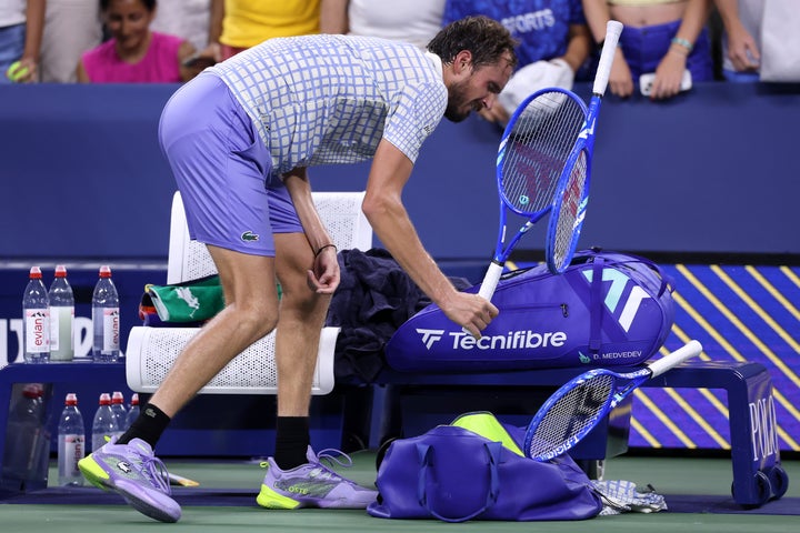 Daniil Medvedev breaks his racket after losing in five sets to Benjamin Bonzi of France.