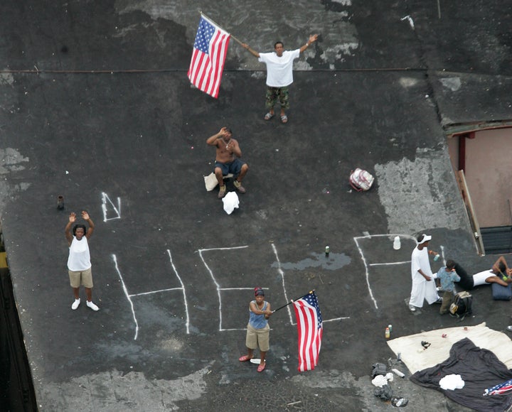In this Sept. 1, 2005, file photo, residents wait on a rooftop to be rescued from the floodwaters of Hurricane Katrina in New Orleans. 