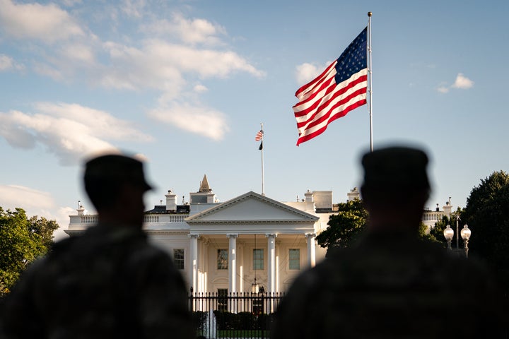 Members of the National Guard after an individual lit an American flag in flames in Lafayette Park outside the White House on Monday.