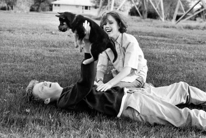 Hall and Molly Ringwald playing with a puppy during a break in location shooting of “The Breakfast Club” in 1984.